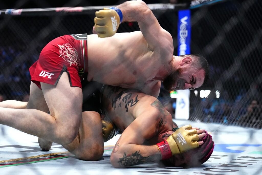 Merab Dvalishvili takes down Sean O'Malley, showcasing his dominant wrestling during their UFC title fight.